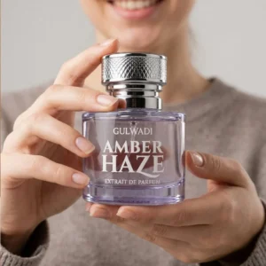 Amber Haze perfume by Gulwadi held in hands - warm amber and vanilla fragrance