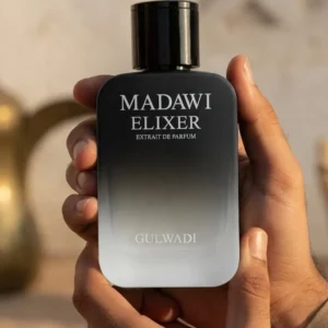 Madawi Elixir perfume by Gulwadi held in hands - black gradient luxury bottle