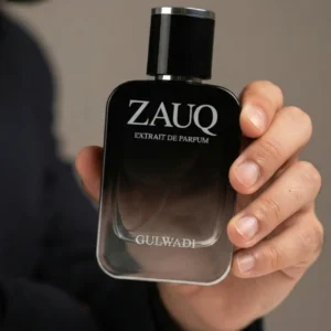 Zauq perfume by Gulwadi held in hand - black gradient oud honey perfume bottle